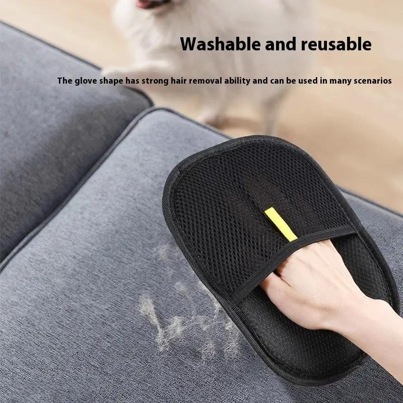 Pet hair remover glove in black mesh, reusable deshedding mitt being used on a sofa.