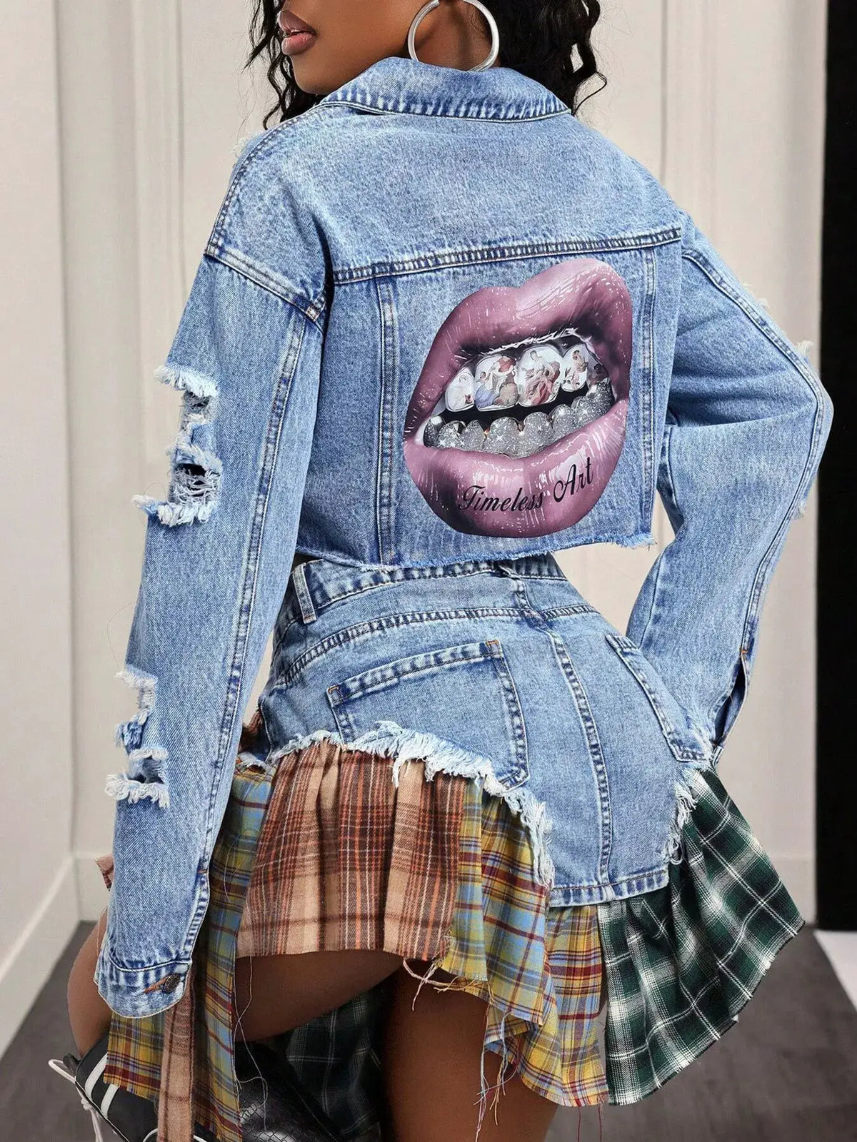 Distressed cropped blue denim jacket with back lips graphic patch