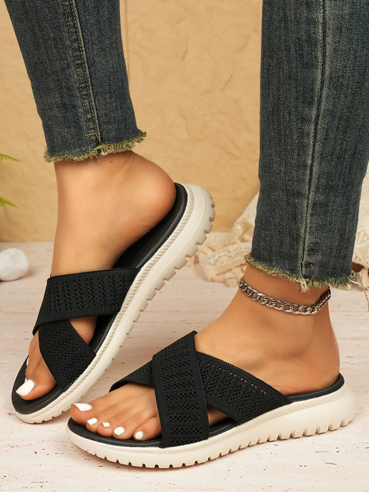 Cross-Strap Platform Sandals; black woven straps with a white chunky sole, shown worn with frayed-hem jeans