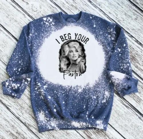 Blue tie-dye Dolly Partin sweatshirt with black-and-white portrait and I Beg Your Parton text