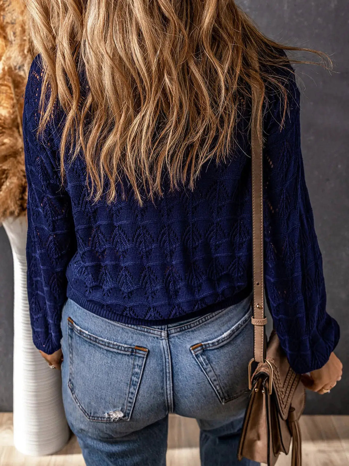 Button-front openwork cardigan in navy with textured stretch knit, back view.