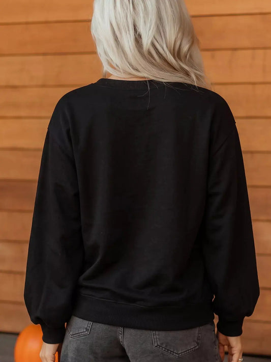 Sweatshirt, black long-sleeve round-neck, back view with ribbed cuffs and hem.