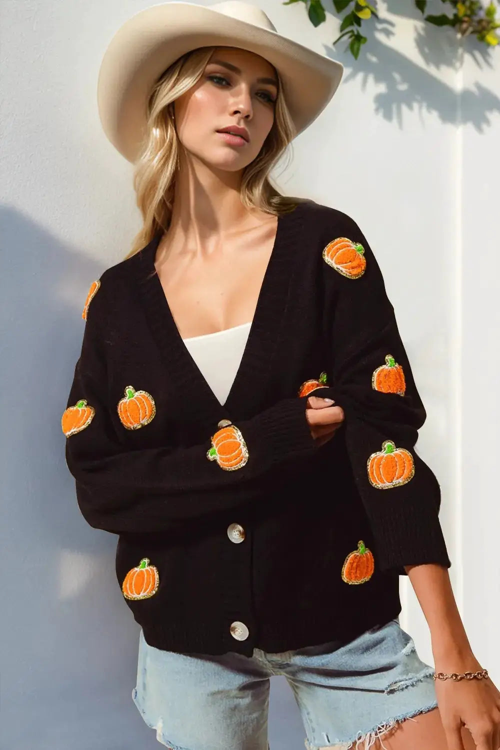 Black pumpkin-embroidered long-sleeve cardigan with button front; plus-size