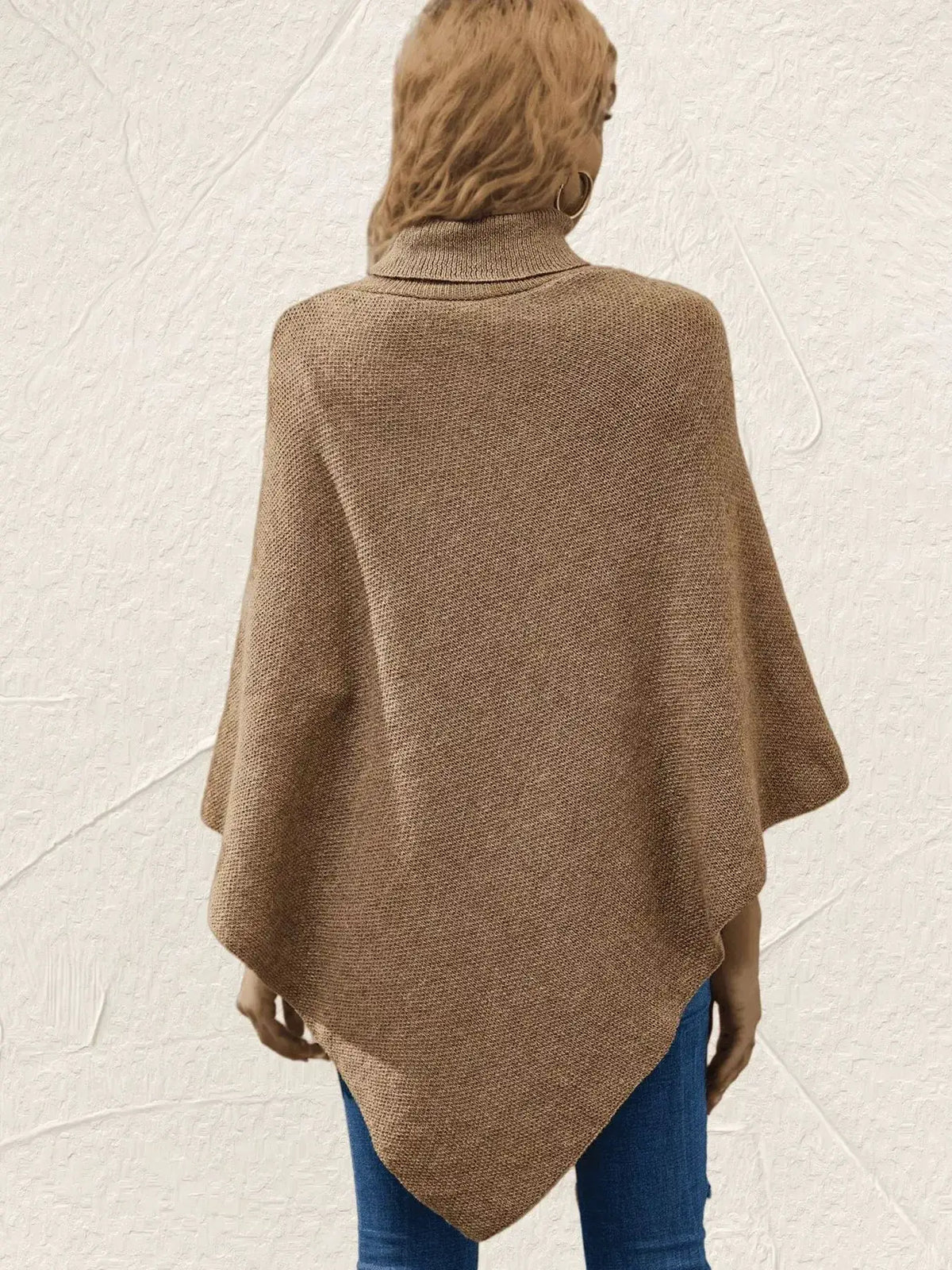 Camel textured knit poncho pullover, back view; relaxed cape-style sweater over blue jeans