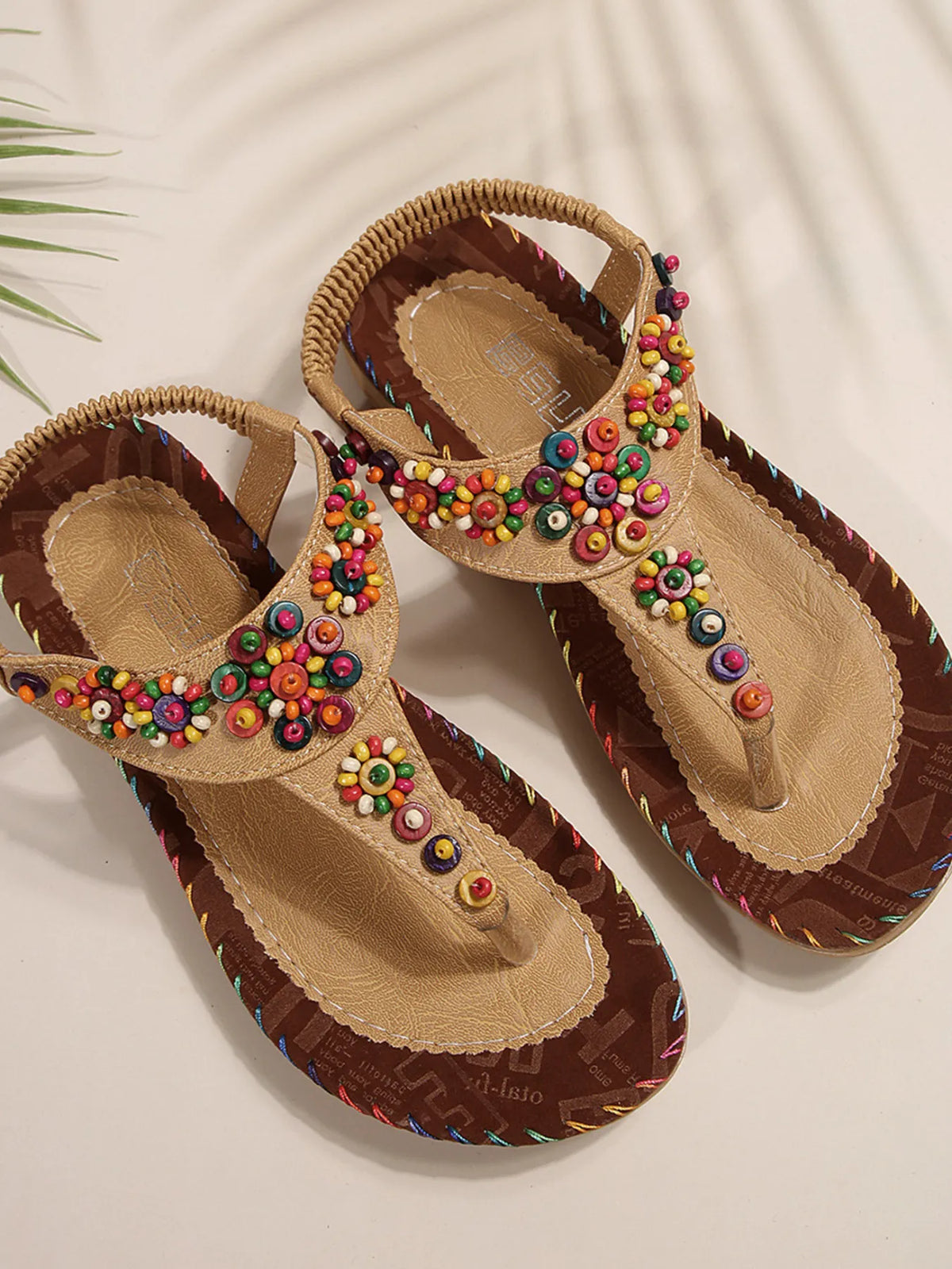 Colorful beaded T-strap flat sandals; tan leather with vibrant beadwork by Trendsi