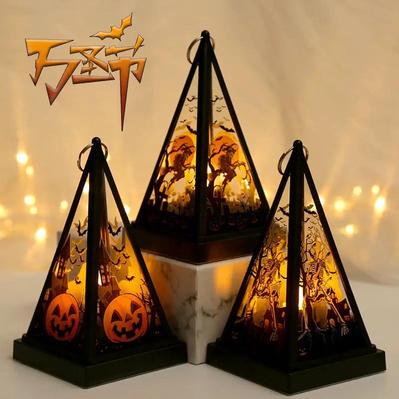 Pumpkin lantern trio by AdTec with black pyramid frames and amber panels showing pumpkins and witches for display.