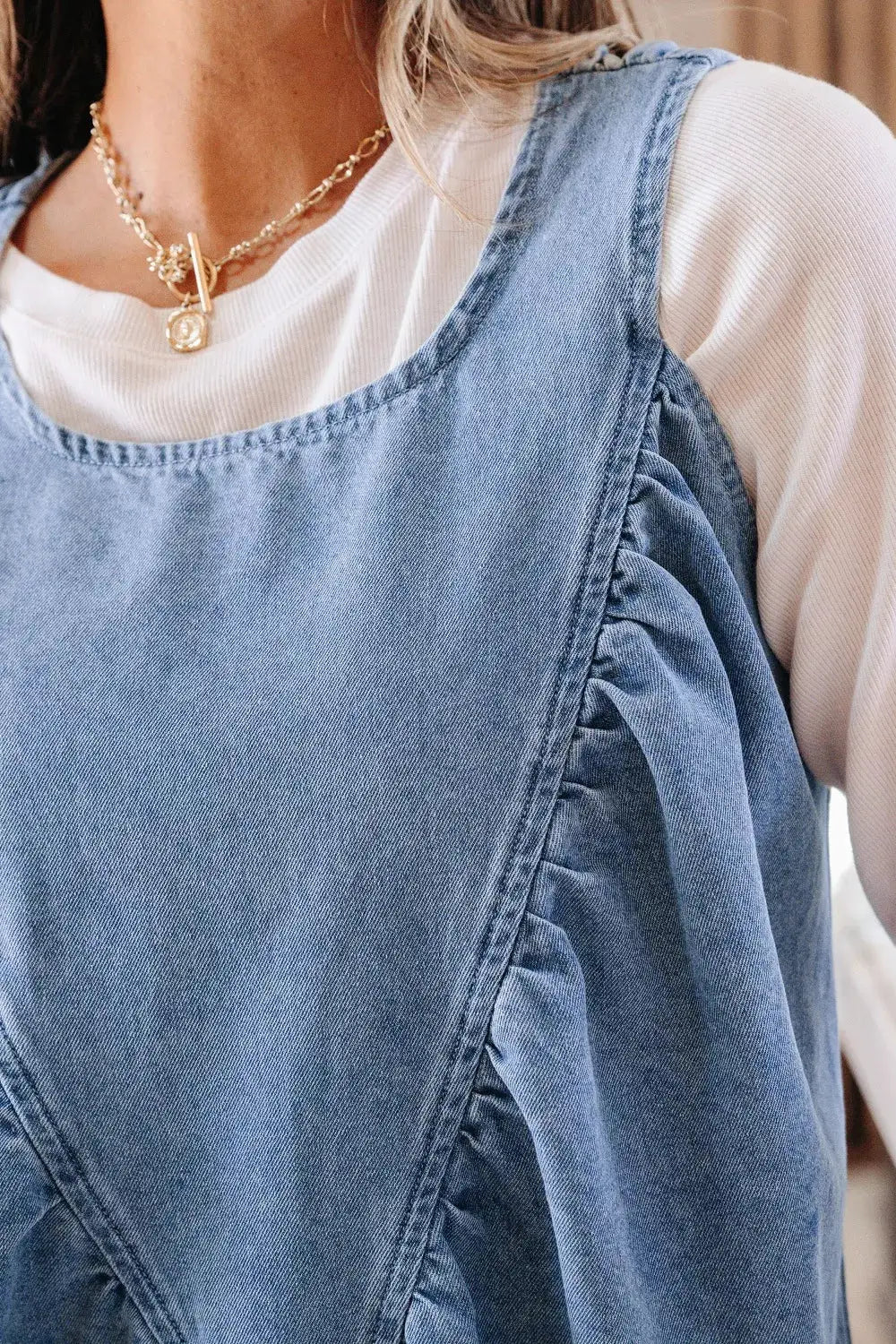 Women’s light-blue denim sleeveless top with ruffle side detail