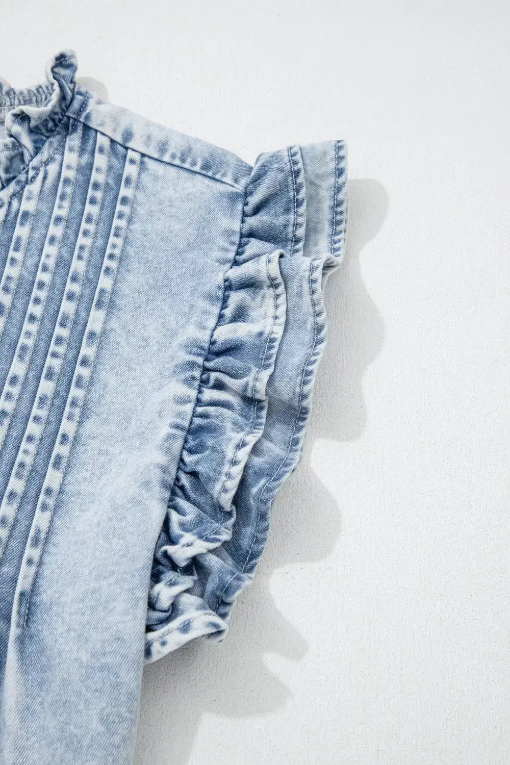 Vintage washed denim top with pleated front and ruffled sleeve edge