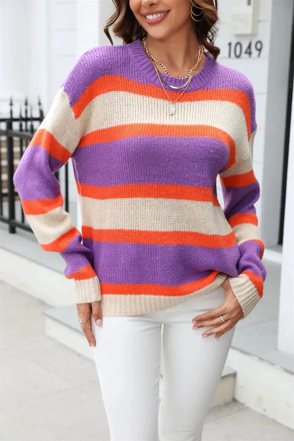 Angel Wings color-block knit sweater with purple, orange, and cream stripes; round neck, dropped shoulders.