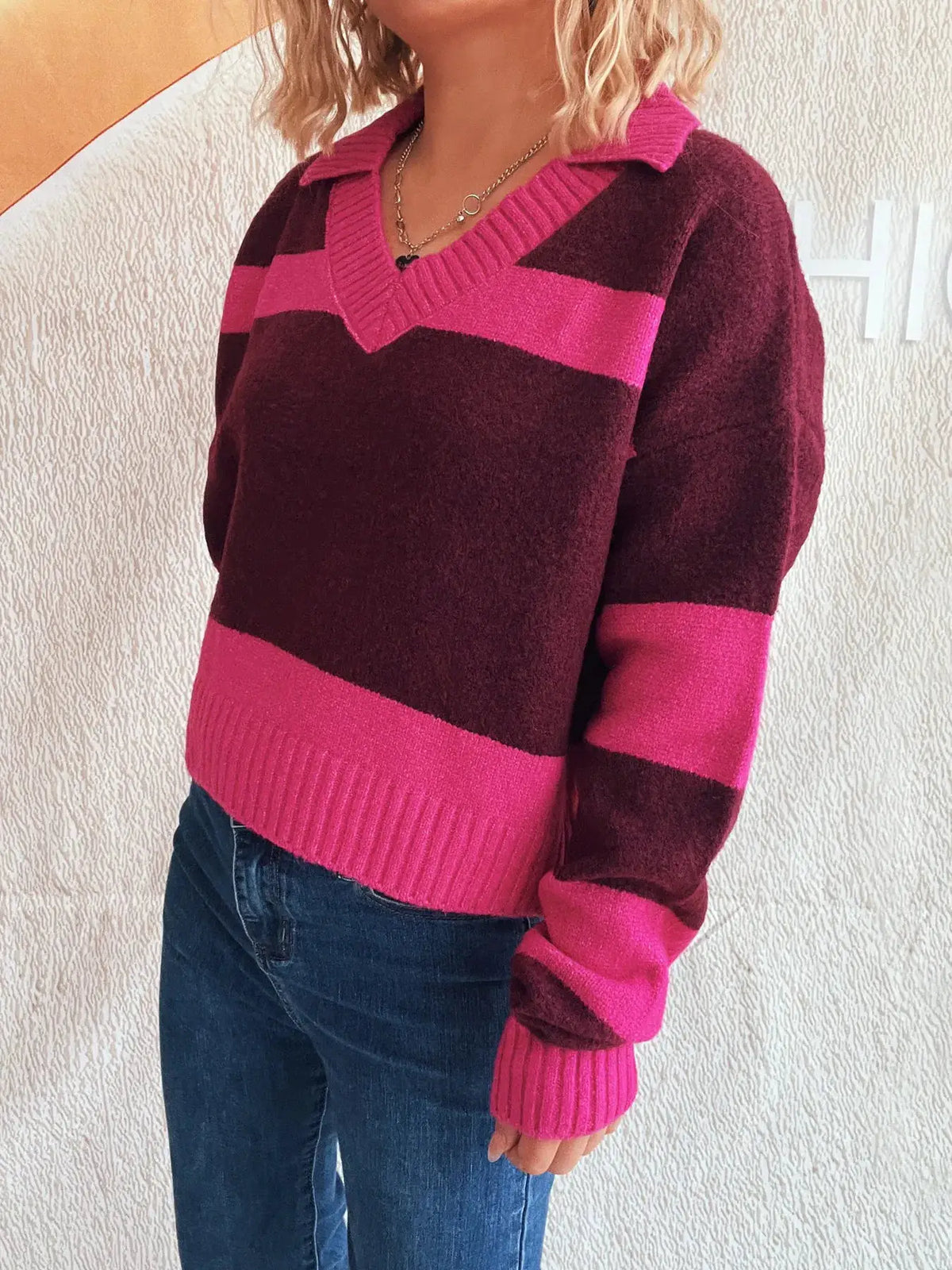 Color-block long-sleeve sweater in pink and burgundy with a ribbed V-neck collar; soft stretch polyester blend