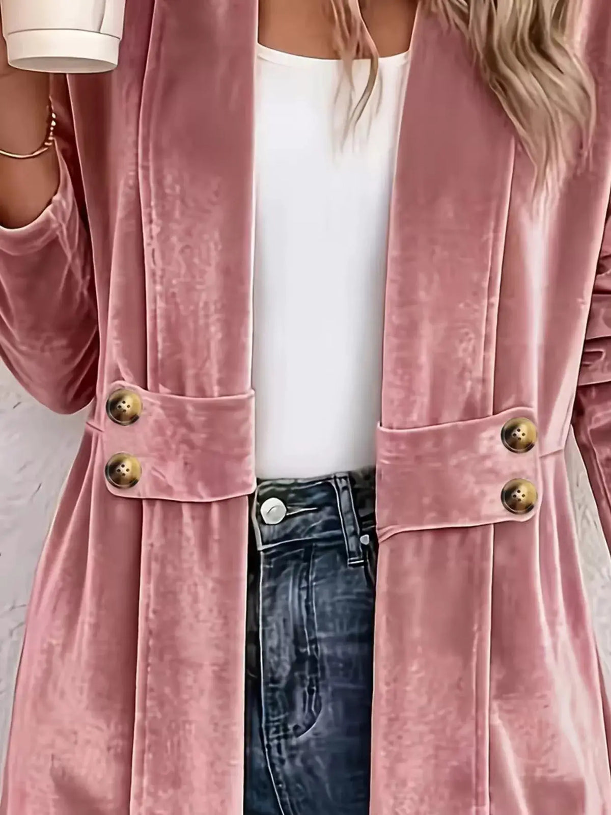 Elegant velvet open-front coat in pink with gold-tone buttons worn over a white top