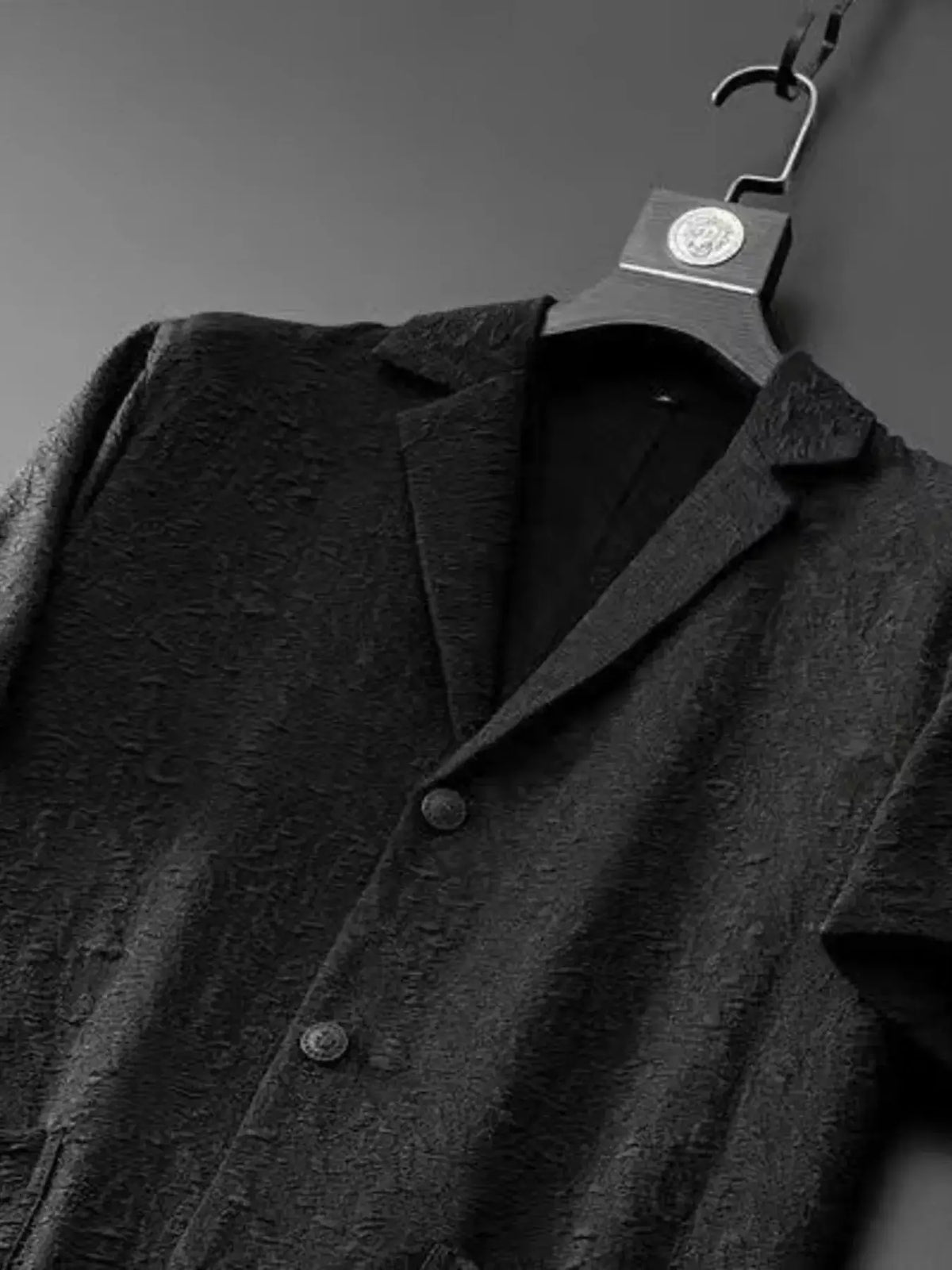 Mens plus-size button-up shirt on a hanger in dark charcoal textured fabric