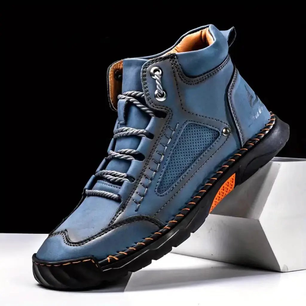 Aveline Handcrafted Ankle Boots by AdTec, blue leather with a rugged black sole and orange accent.