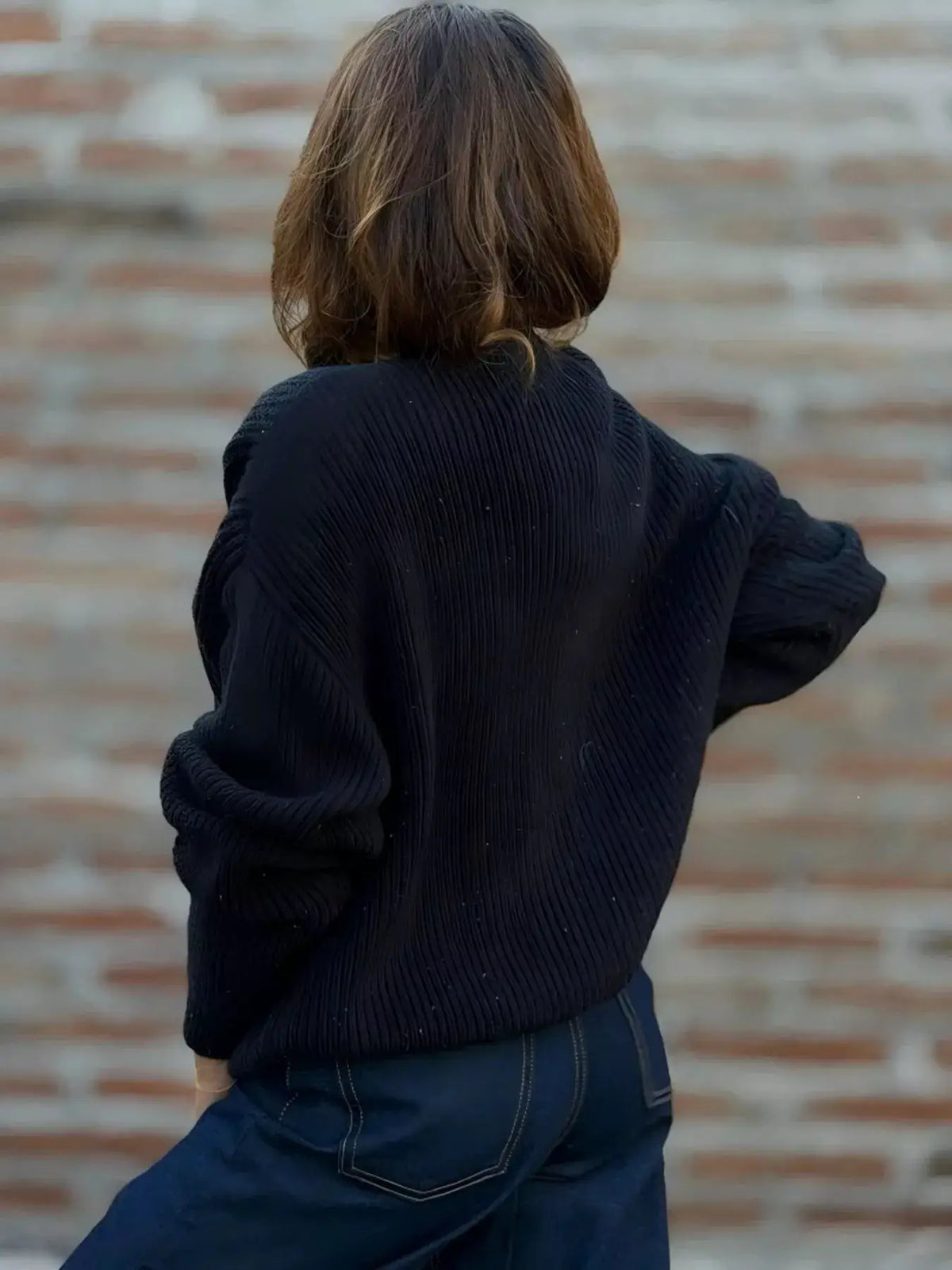 Plus size V-neck button-up knit cardigan in black with ribbed texture and slight stretch