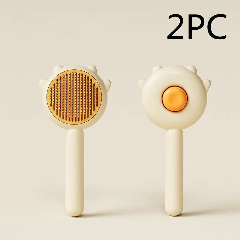 AdTec 2-piece cat and dog grooming comb set, cream handles with gold bristle head and orange button
