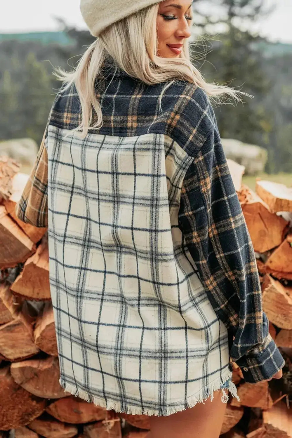 Shacket in multicolor plaid with navy and cream panels, long sleeves, frayed hem.