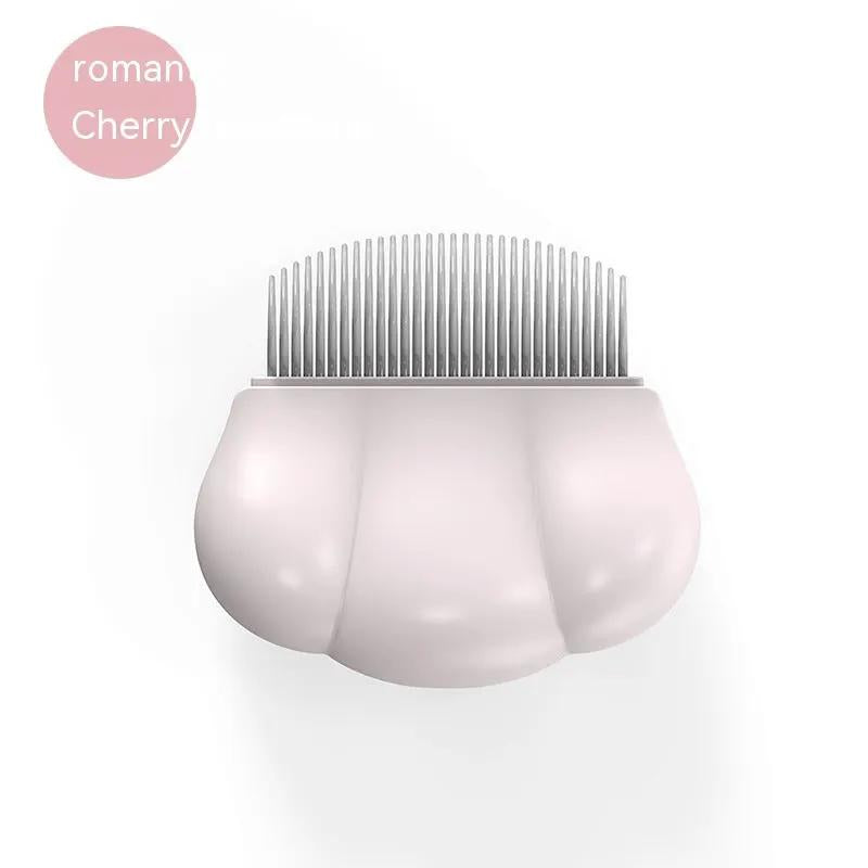 Dog grooming comb with pink shell-shaped handle and fine metal teeth for removing tangles