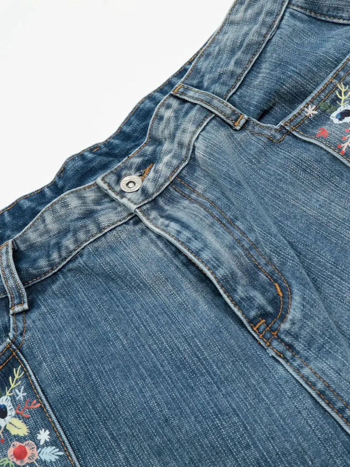 Men's wide-leg denim shorts with floral embroidery trim in blue denim fabric