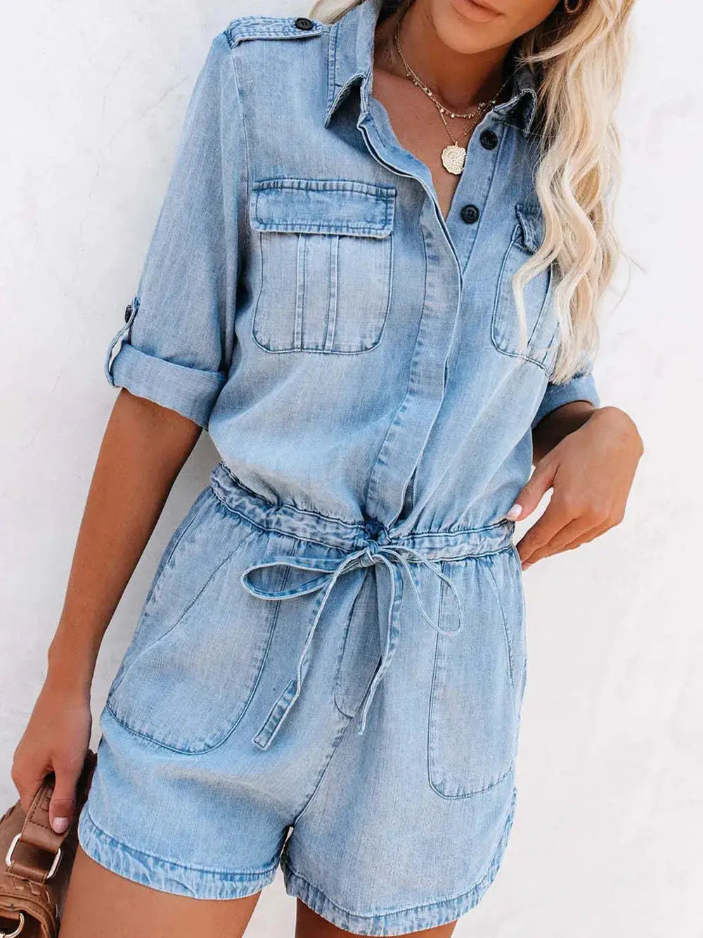 Denim romper with half-button front, rolled short sleeves, drawstring waist, front pockets, light wash — Trendsi