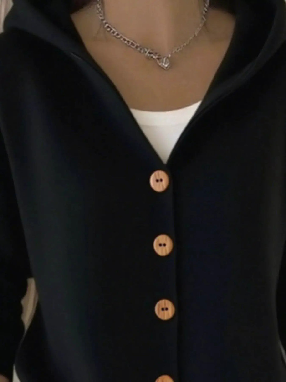 Plus-size navy soft-knit cardigan with hood and front wooden buttons over white top