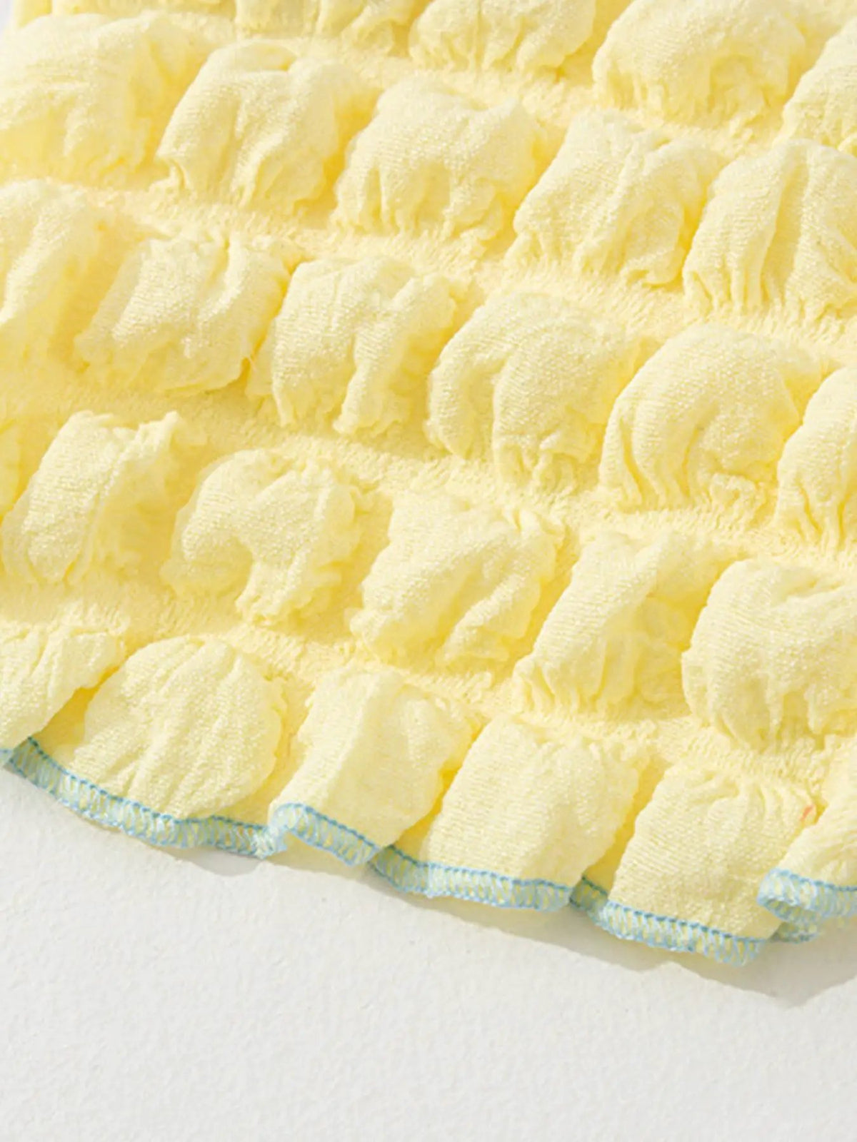 Bubble-textured yellow tie-shoulder pet top with blue-hem trim