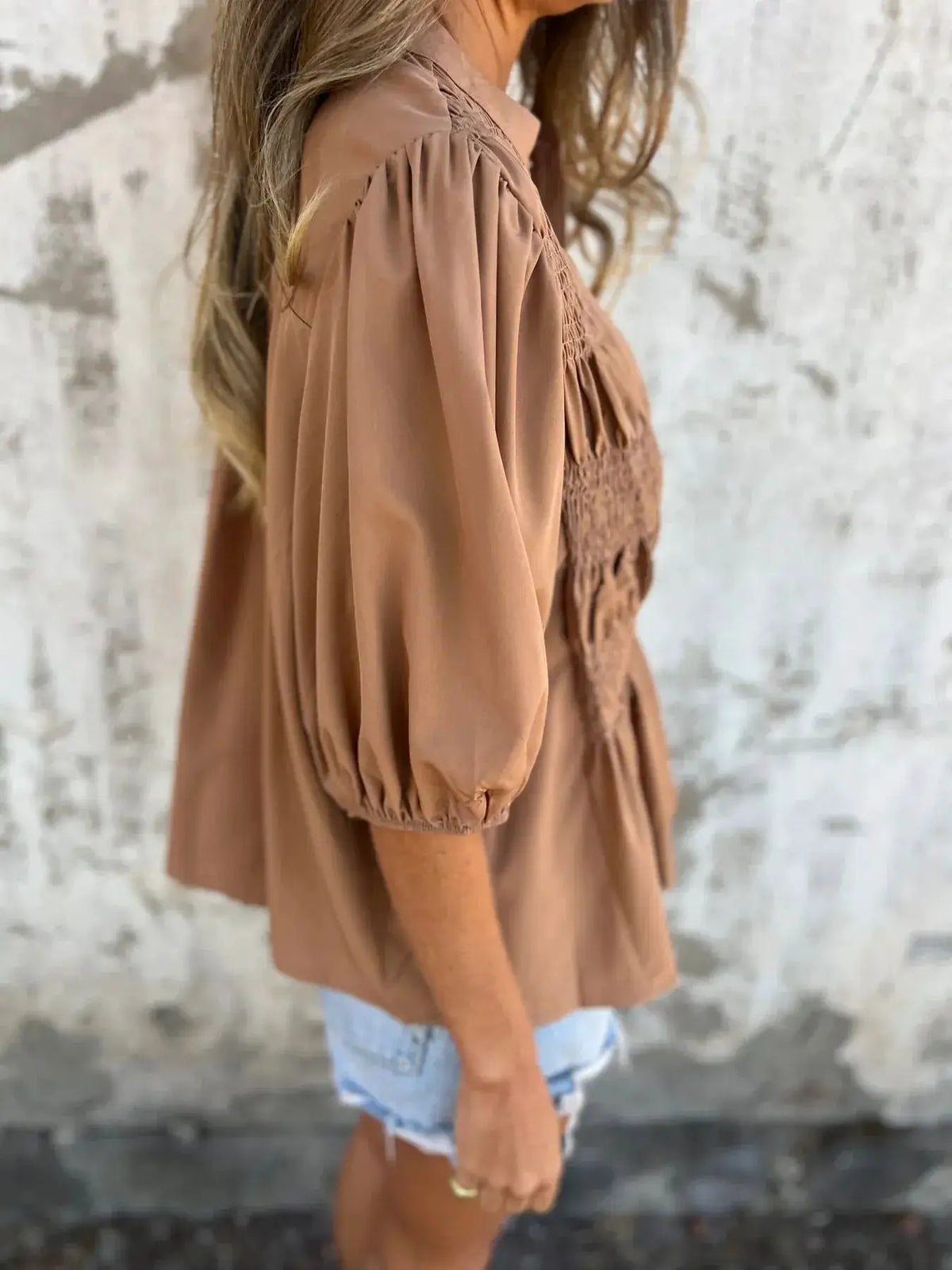 Plus size smocked puff sleeve blouse in tan, loose-fit with smocked bodice.