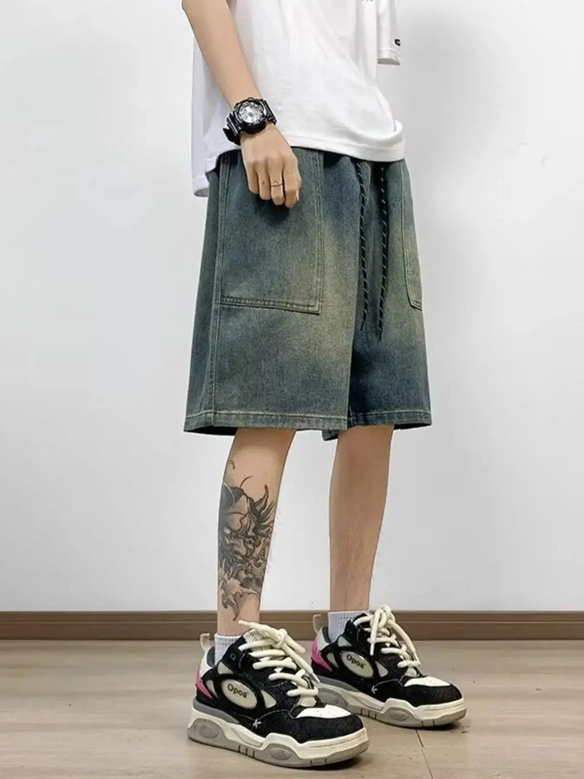 Mens plus-size loose-fit washed denim shorts with stretch, gray denim, drawstring waist, front patch pockets.