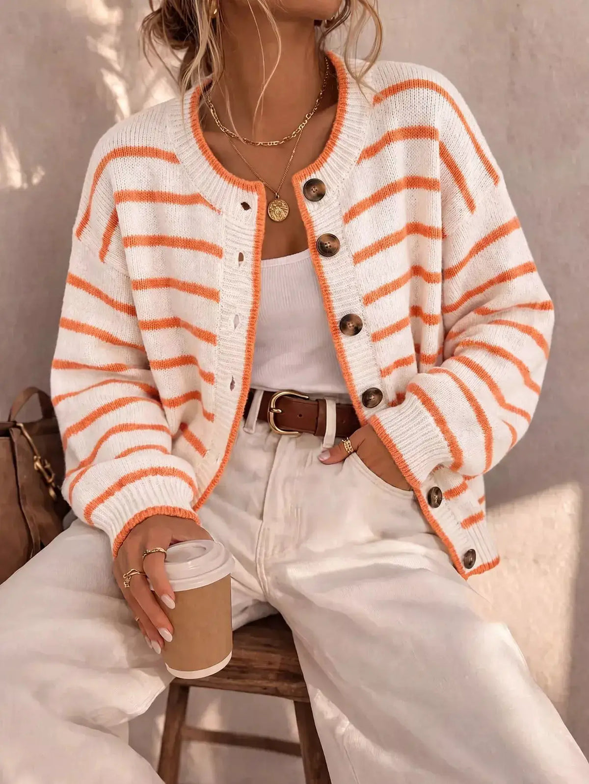 Striped button-down knit cardigan in white with orange stripes, brown buttons, by Trendsi