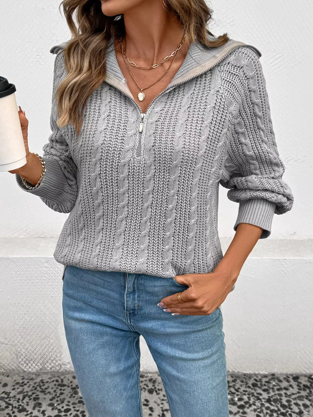 Cable knit half-zip sweater in light gray acrylic, machine washable.