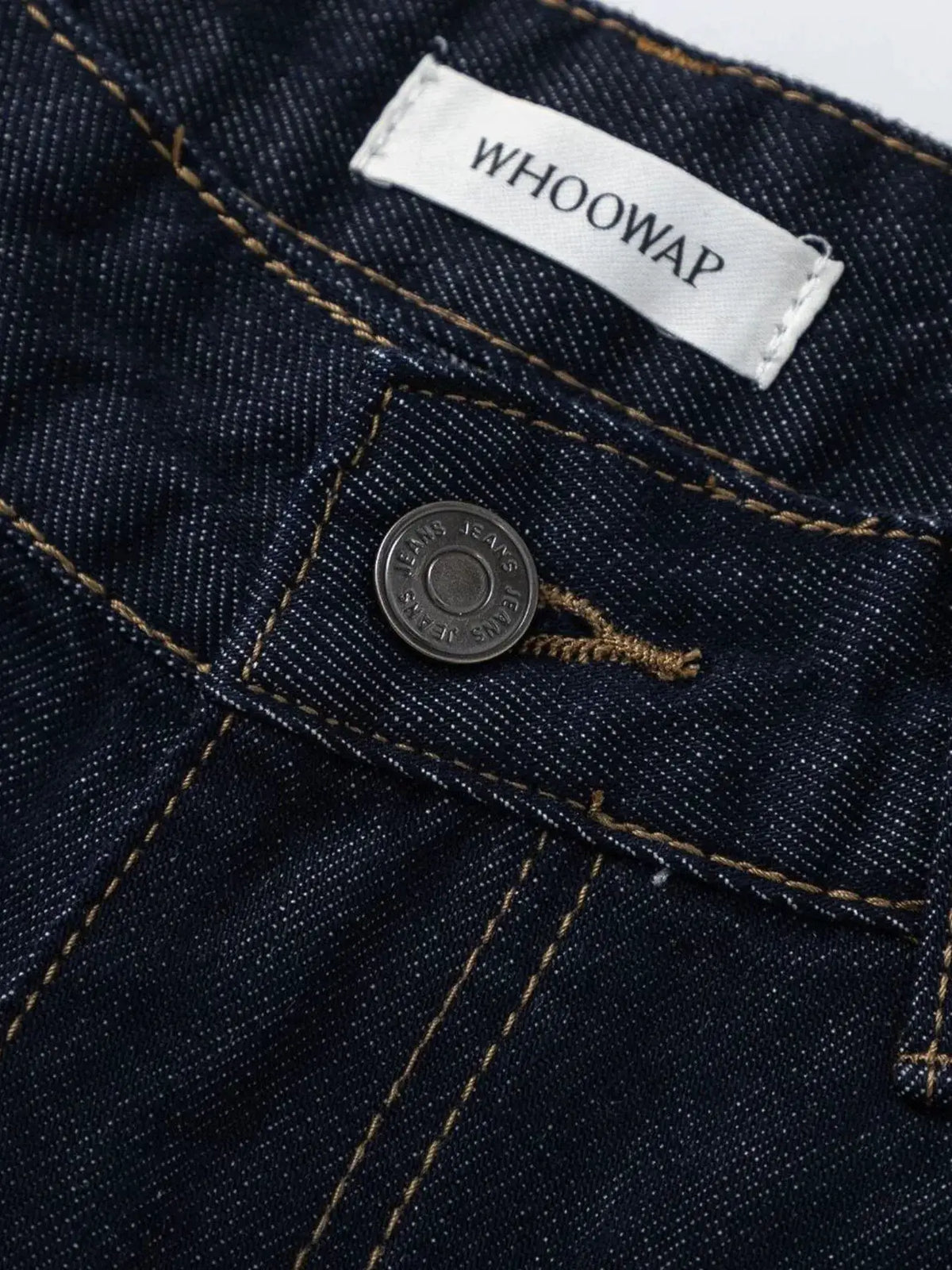 Men's wide-leg denim shorts in dark indigo cotton with metal button and white tag