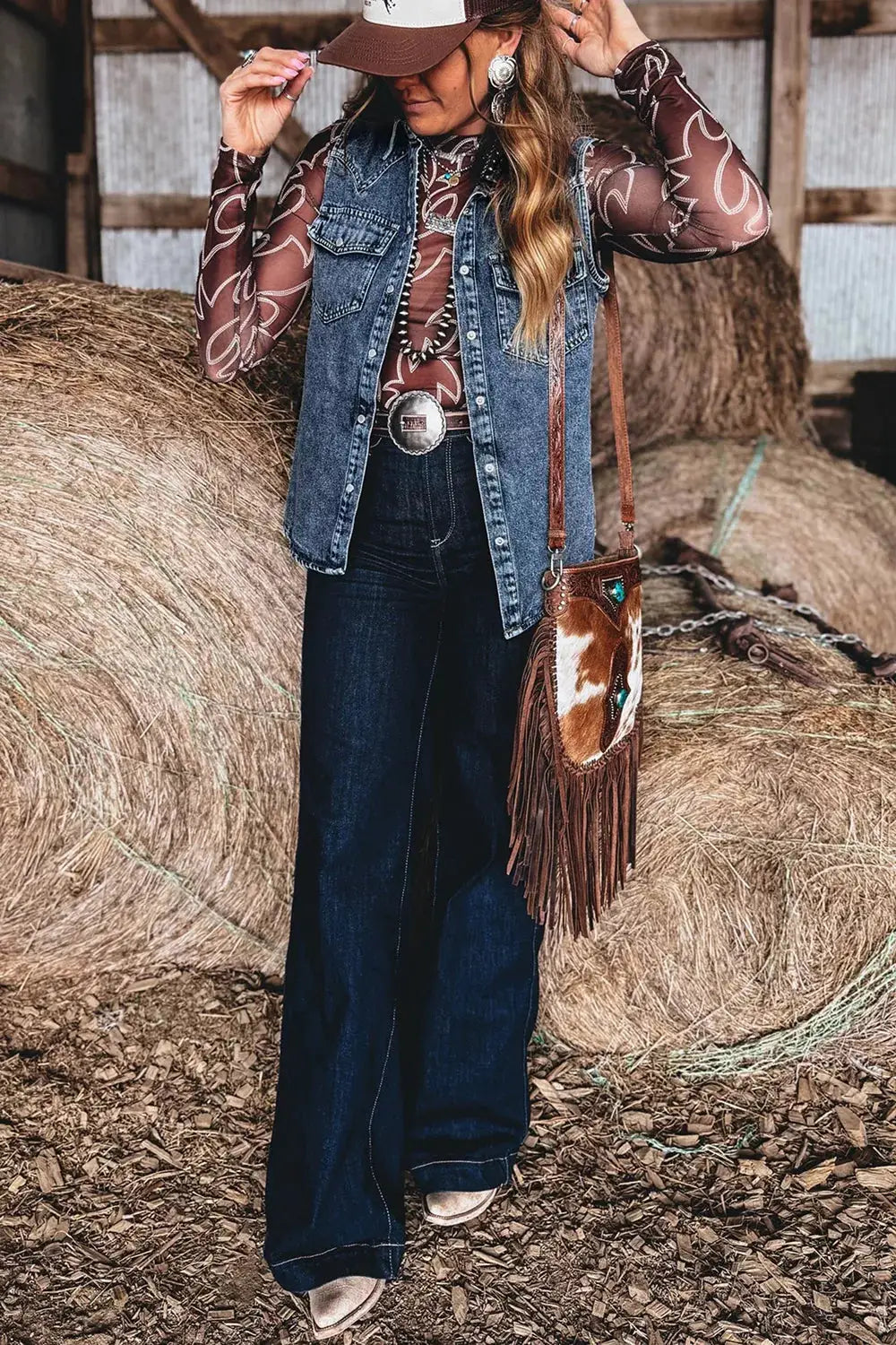 Denim sleeveless cowboy vest in blue with button front and chest pockets