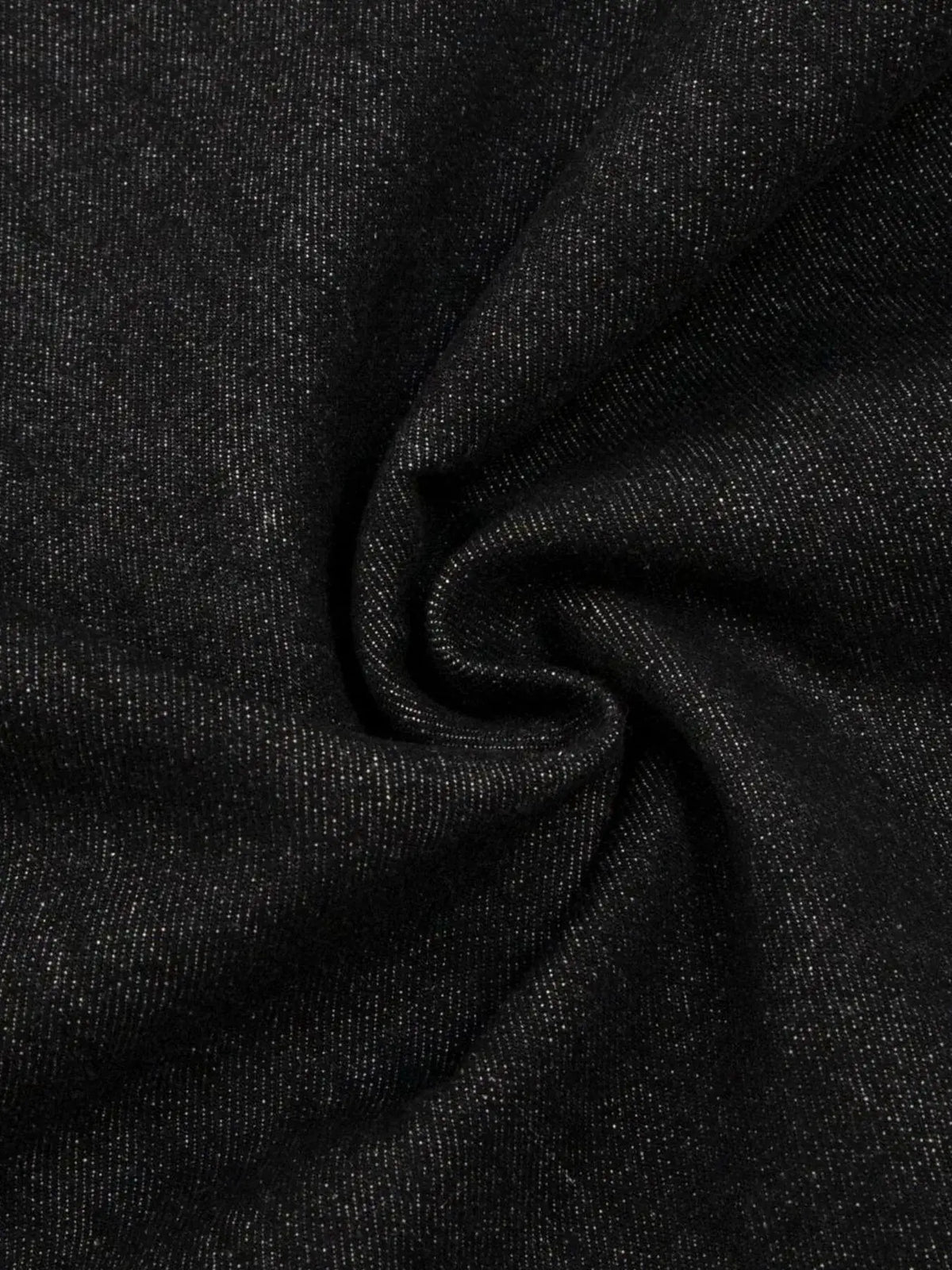 Men's wide leg denim shorts fabric close-up; dark cotton-stretch denim with speckled texture