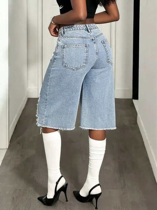 Distressed wide-leg denim shorts by Trendsi in light blue wash with frayed hem, contrast stitching, and back pockets.