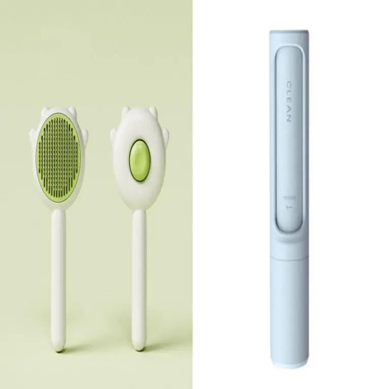 Pet grooming set: two white cat comb massage brushes with green pads and a light-blue handheld grooming device.
