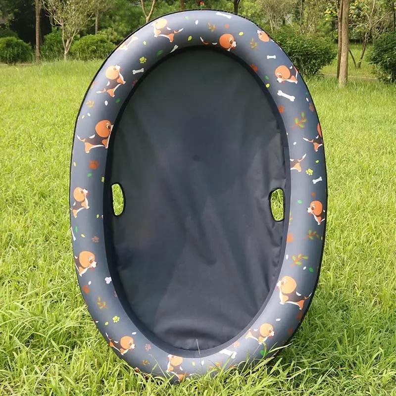 Dog pool inflatable hammock bed, oval shape with dark interior and a dark blue outer rim printed with dogs and bones