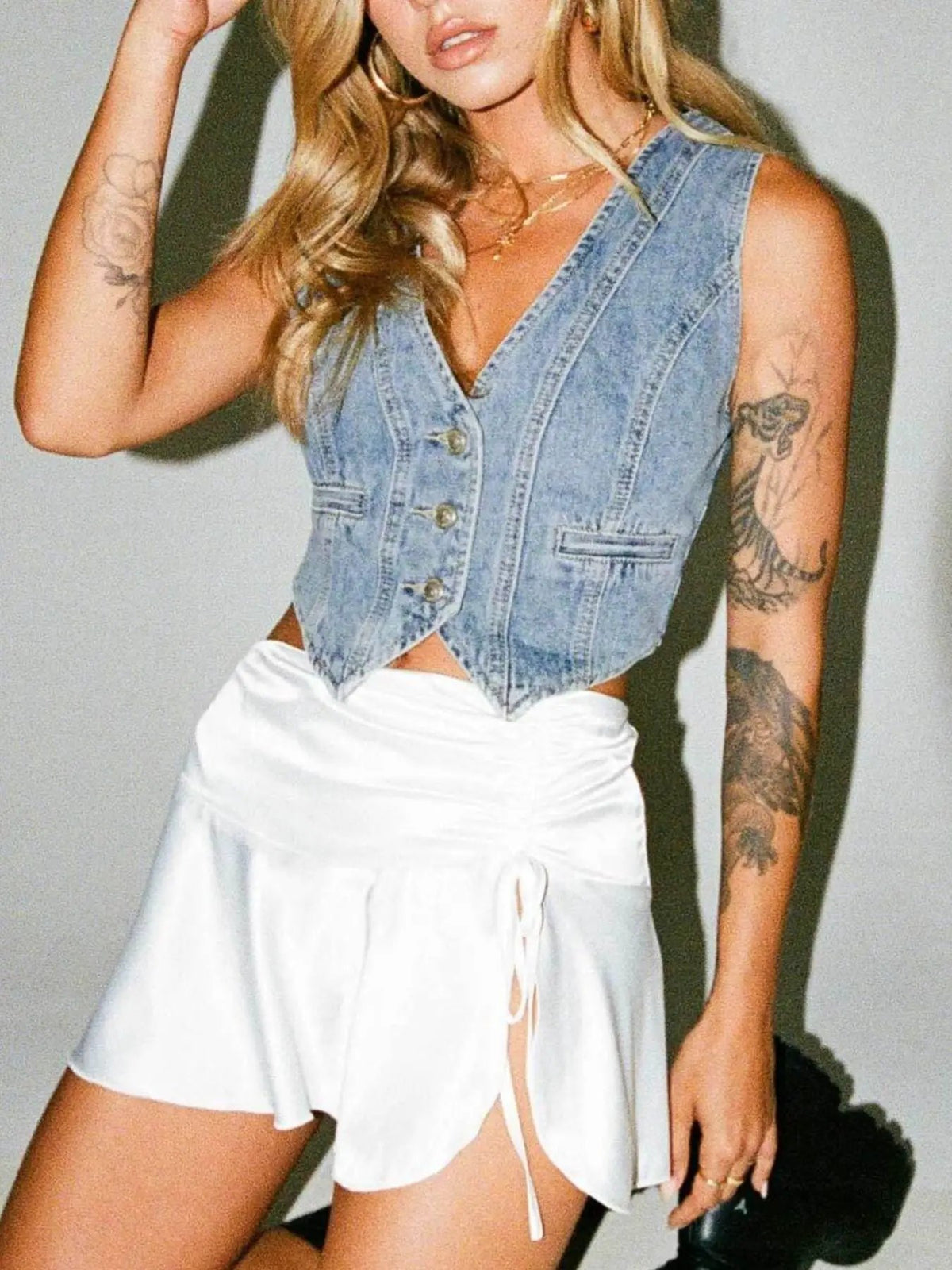 V-neck light-wash denim vest with button-front, sleeveless, front pocket