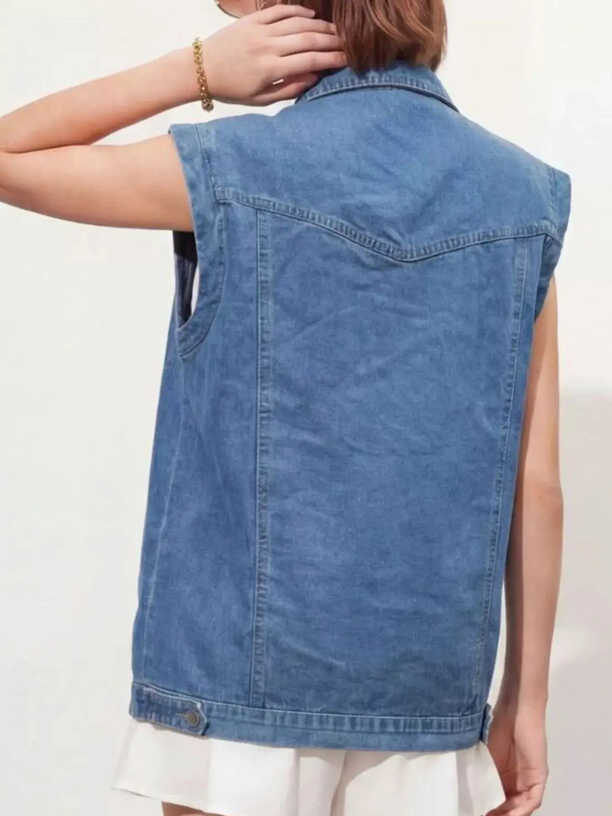 Denim vest in faded blue with classic hardware back view, relaxed fit