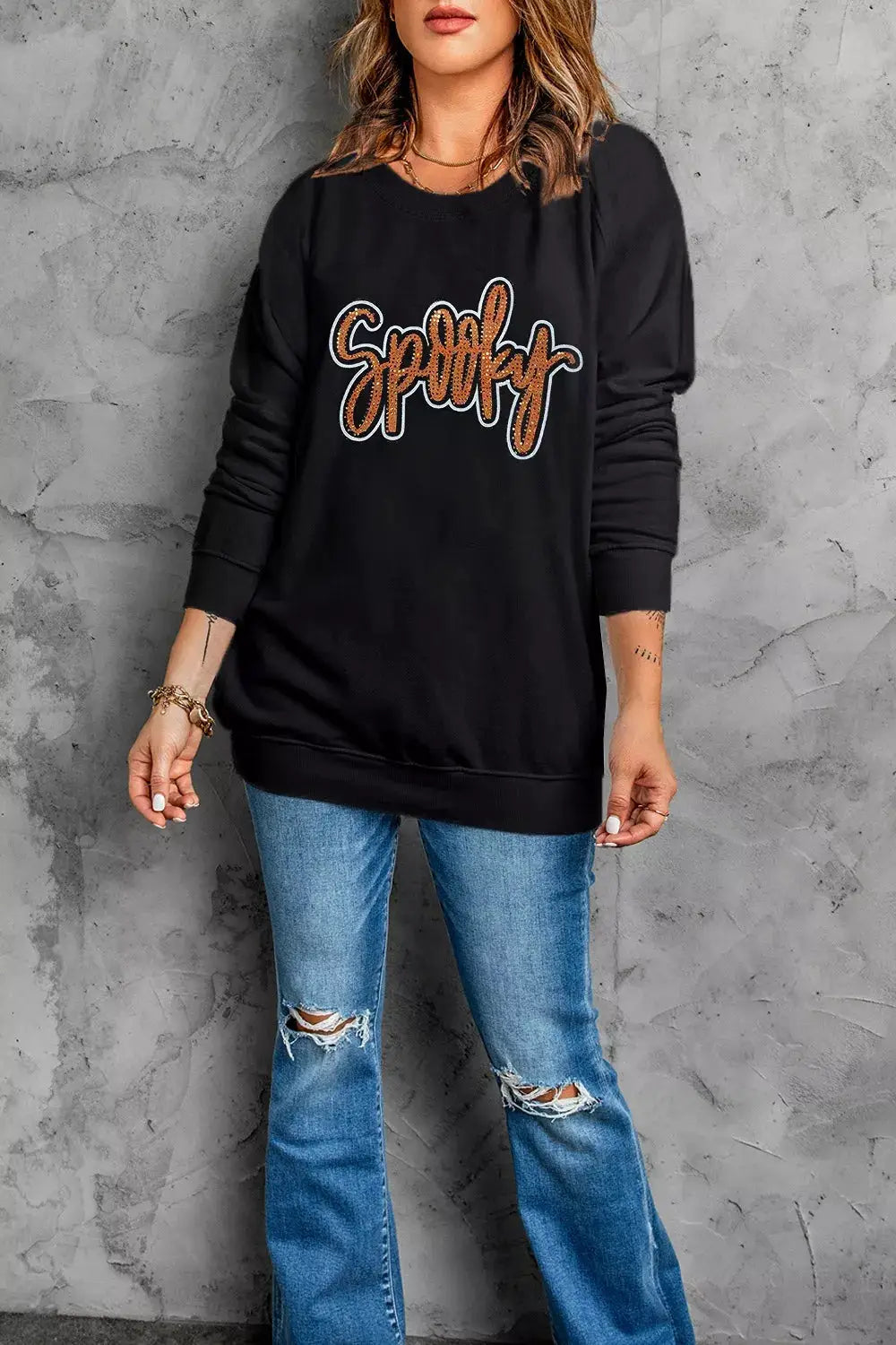 Spooky Rhinestone Drop-Shoulder Sweatshirt in black with orange rhinestone lettering