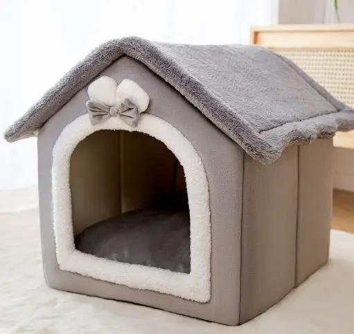 AdTec foldable dog house bed with plush grey exterior, bow at the entrance, warm enclosed shelter for pets.