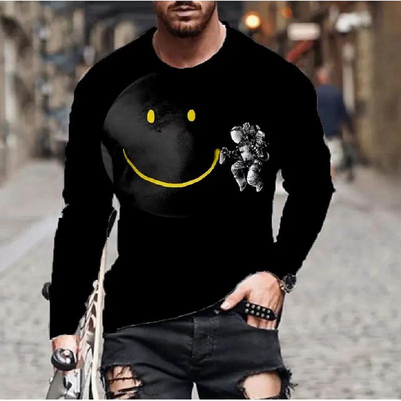 Men's black long-sleeve T-shirt featuring a yellow smiley graphic and astronaut detail