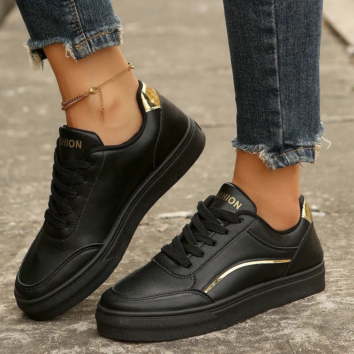 AdTec lace-up black sneakers with gold accents and thick soles; one pair.