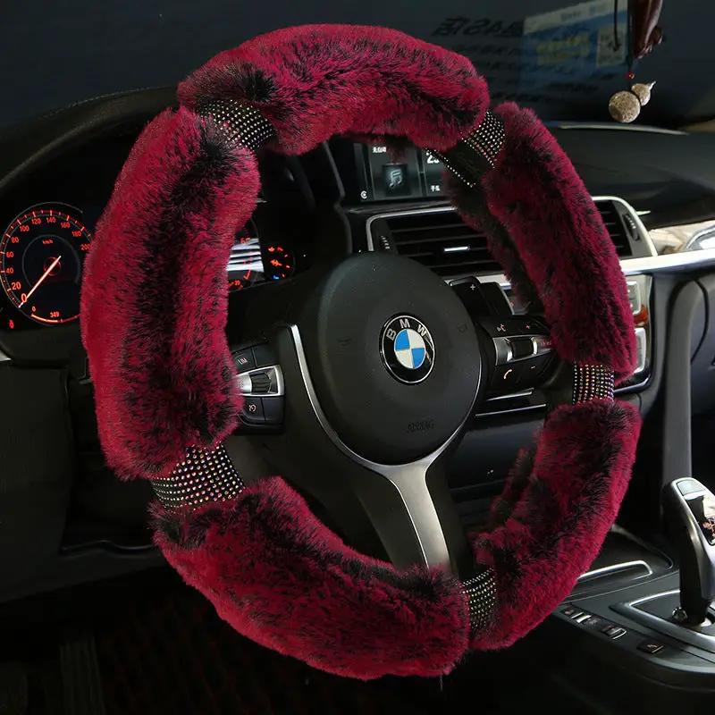 Red plush steering wheel cover with diamond-accents and studded bands