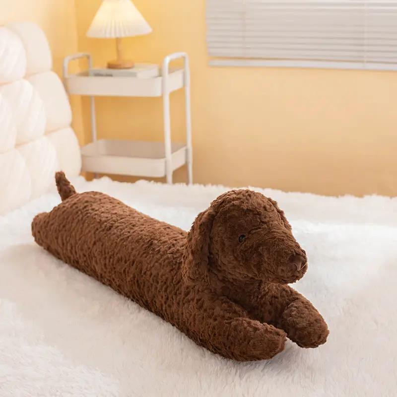 Dachshund plush long pillow cuddle toy in brown on a white fluffy bed