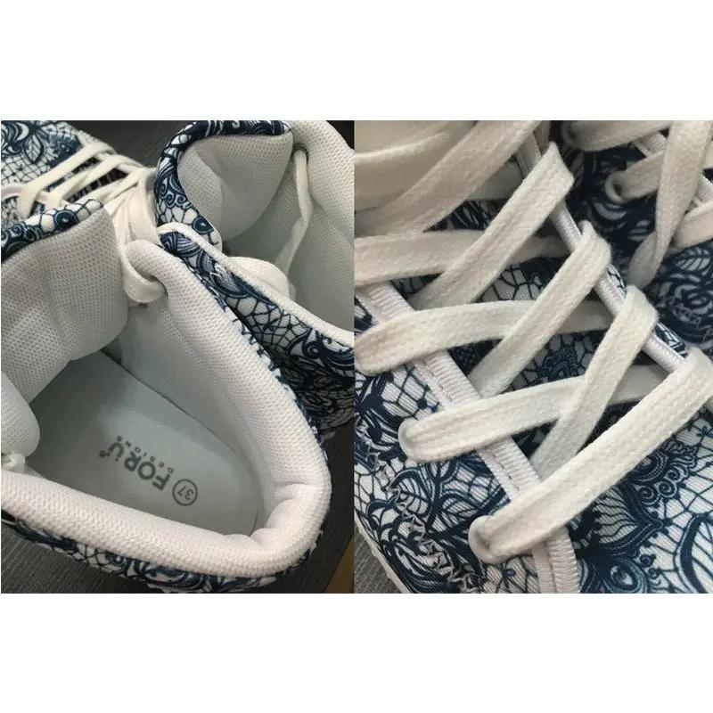 Women's high-top sneakers with white laces and blue lace-pattern fabric