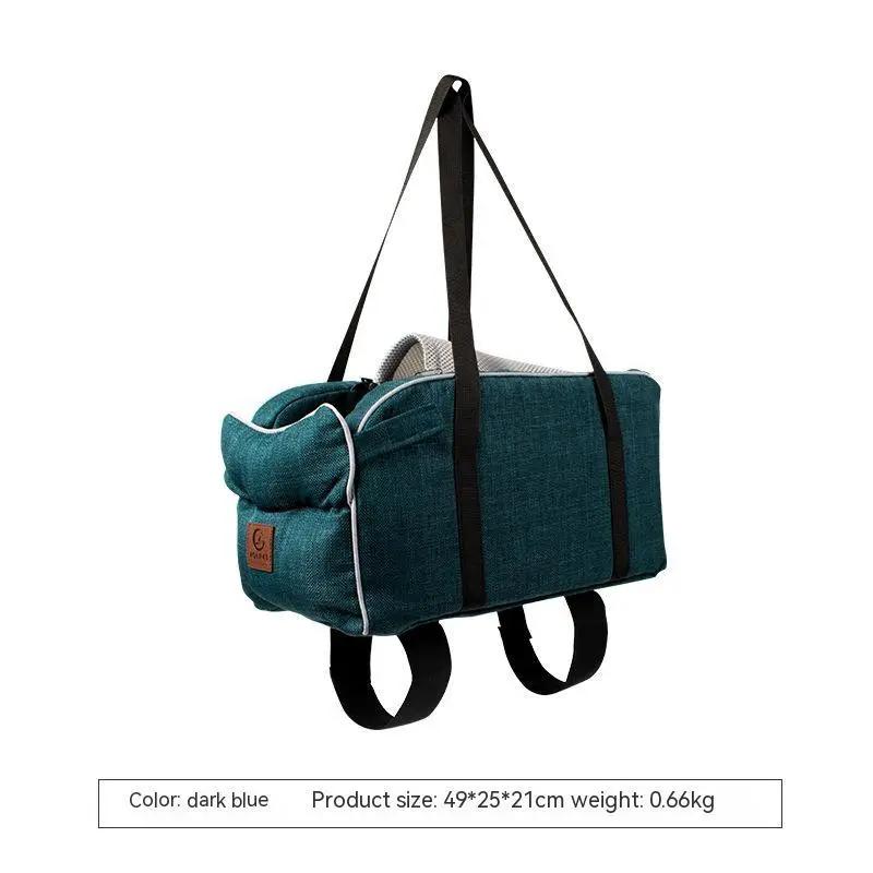 Pet car bag in dark teal breathable fabric with black shoulder straps and seat loops