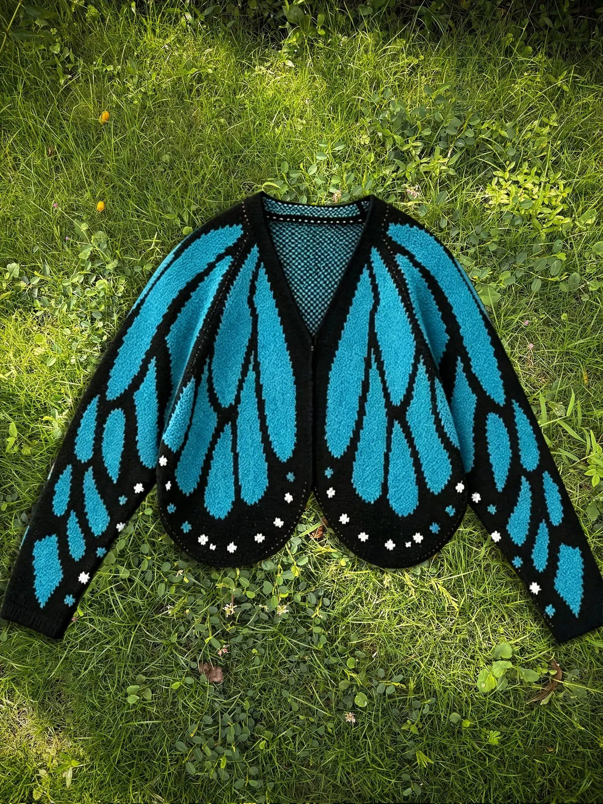 Women's butterfly knit cardigan sweater by AdTec in turquoise and black, long sleeve, open front.