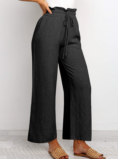 Pantalon large à taille élastique, lacets et coupe courte de couleur unie