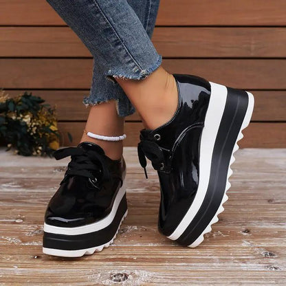 Pair of AdTec women's lace-up square-toe patent leather platform wedge heels in black with a chunky white sole.