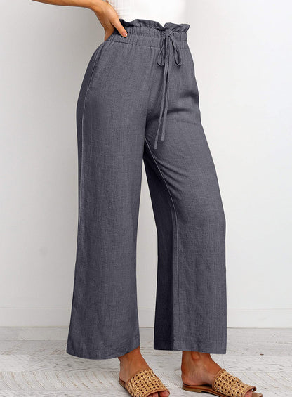 Pantalon large à taille élastique, lacets et coupe courte de couleur unie