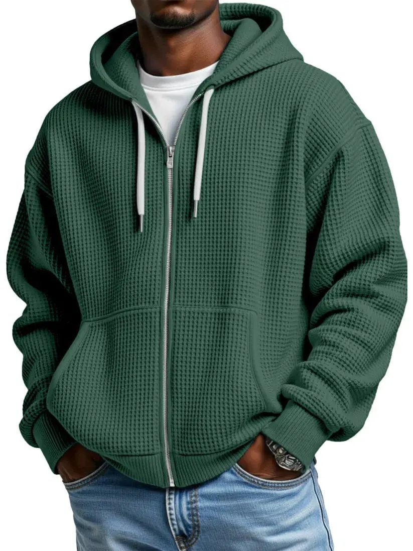 Men's green zip-up hoodie with kangaroo pockets, ribbed cuffs and hood drawstrings, waffle-knit texture.